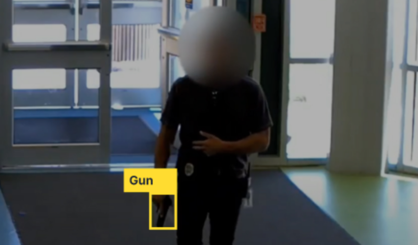 Security camera footage of man with gun, the image has the gun highlighted and labeled